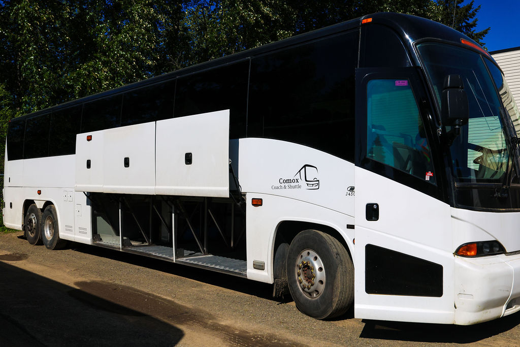 Comox Coach & Shuttle MCI highway coach with luggage bays open